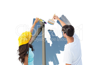 Composite image of happy young couple painting together