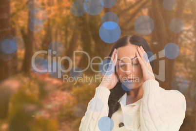 Composite image of woman suffering from a migraine