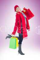 Happy blonde in winter clothes holding shopping bags