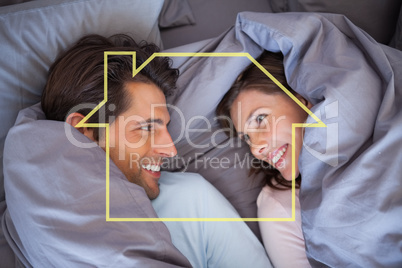 Composite image of couple having fun wrapped in their blanket