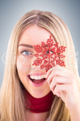 Happy blonde holding red snowflake