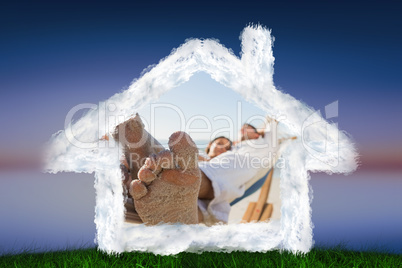 Composite image of close up of sandy feet of couple in a hammock