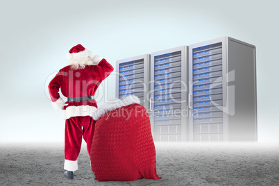 Composite image of santa with sack of gifts