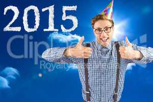 Composite image of geeky hipster wearing party hat smiling at ca