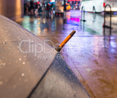 Open umbrella on a rainy night in Times Square