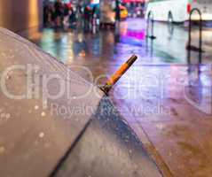 Open umbrella on a rainy night in Times Square