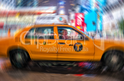 Blurred moving yellow cab in the night of Times Square, Manhatta