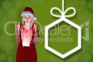 Composite image of festive blonde opening a gift bag