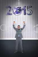 Composite image of happy businessman cheering