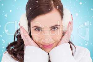 Composite image of pretty brunette with ear muffs