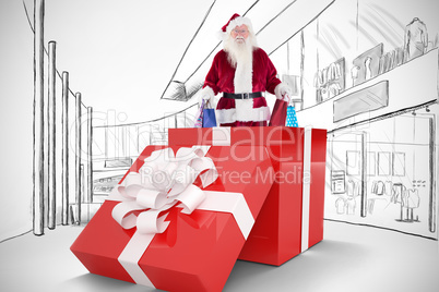 Composite image of santa standing in large gift