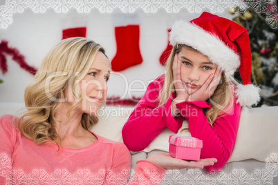 Composite image of festive mother and daughter with gift