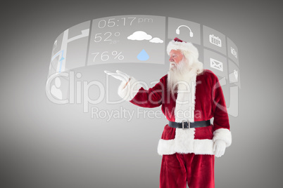 Composite image of santa shows something to camera