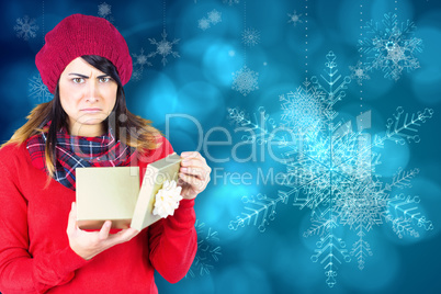 Unhappy brunette opening christmas gift