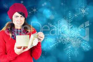 Unhappy brunette opening christmas gift