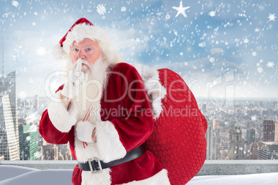 Composite image of santa asking for quiet with bag