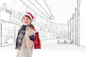 Composite image of smiling woman wearing santa hat