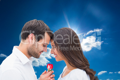 Composite image of handsome man offering his girlfriend a rose