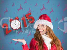 Composite image of festive redhead presenting with hand