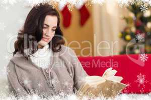 Composite image of relaxed brunette reading on the couch at chri