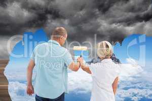 Composite image of happy older couple painting