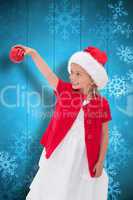 Composite image of cute little girl wearing santa hat holding ba