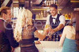 Composite image of attractive friends being served cocktails