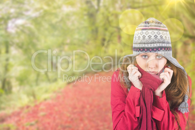 Composite image of cold redhead wearing coat and hat