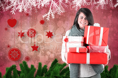 Smiling brunette holding many gifts