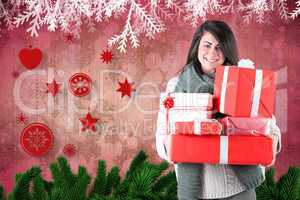 Smiling brunette holding many gifts