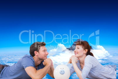 Composite image of couple lying on the floor