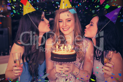 Composite image of attractive friends celebrating a birthday