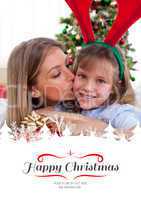 Composite image of loving mother kisses daughter at christmas