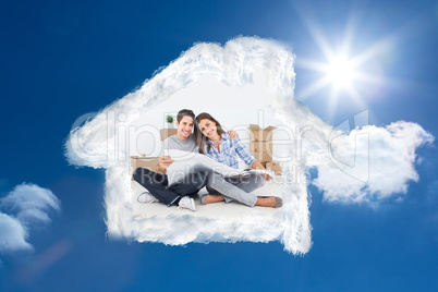 Composite image of man and woman holding house plans