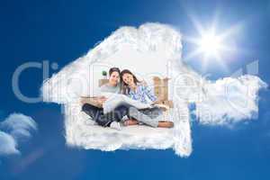 Composite image of man and woman holding house plans