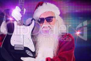 Composite image of father christmas shows a guitar