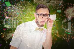 Composite image of geeky businessman eavesdropping with cup