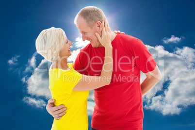 Composite image of happy mature couple hugging and smiling