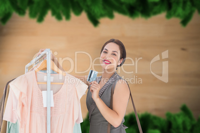 Composite image of woman shopping with card