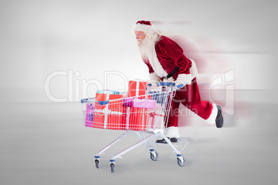 Composite image of santa pushing a shopping cart