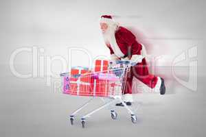 Composite image of santa pushing a shopping cart