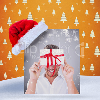 Composite image of man holding gift