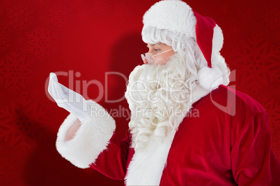 Composite image of father christmas with hand out