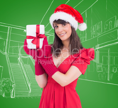 Composite image of cute brunette holding a gift