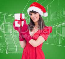 Composite image of cute brunette holding a gift