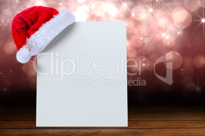 Composite image of santa hat on poster