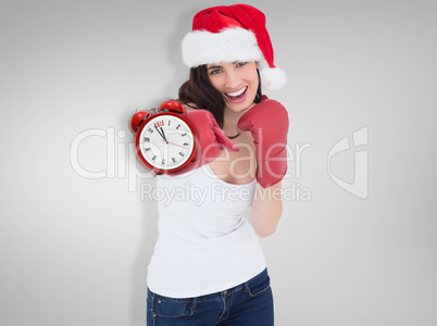 Composite image of festive brunette in boxing gloves punching