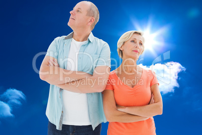 Composite image of thinking older couple with arms crossed