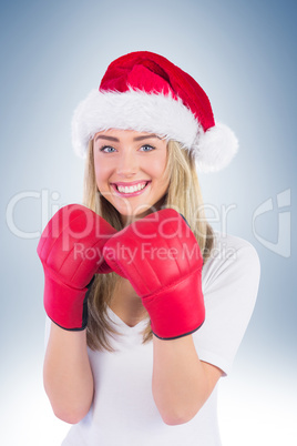 Festive blonde punching with boxing gloves