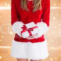 Composite image of sexy santa girl holding gift